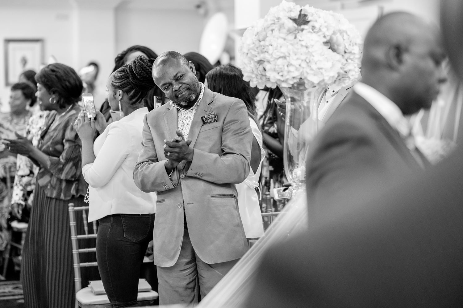 Wedding guests sharing emotional moments during the ceremony.