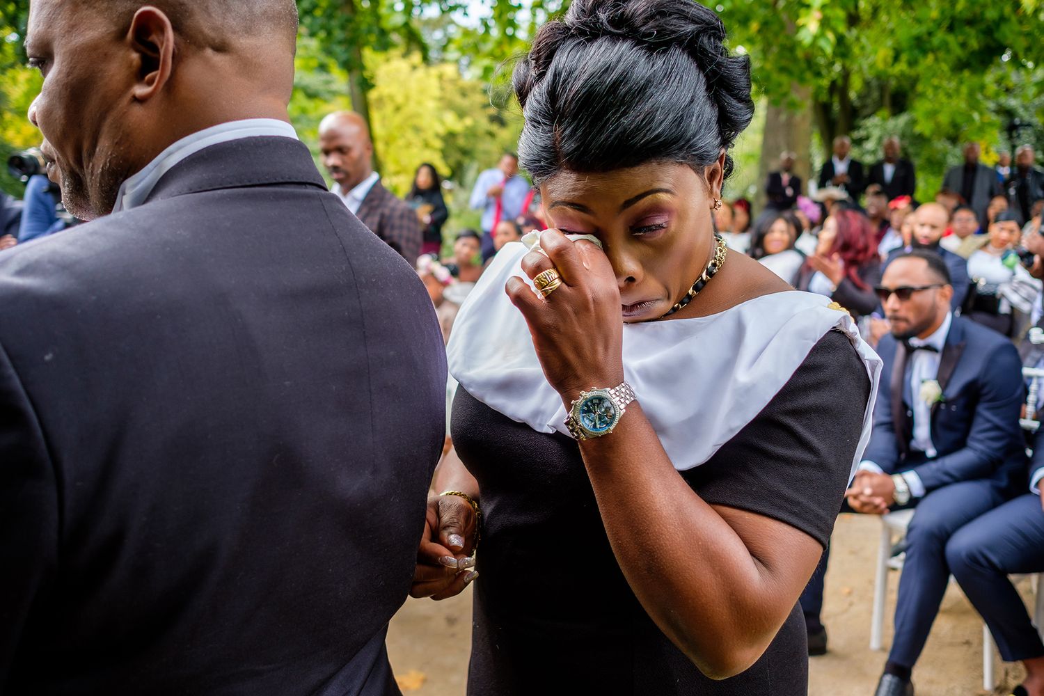 Emotional wedding ceremony scene with attendees sharing touching moments.