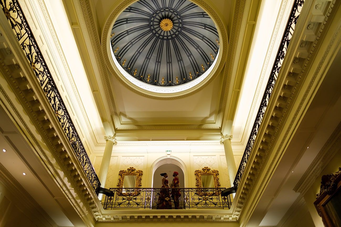 Ornate domed ceiling with classical architectural details illuminated in warm lighting.