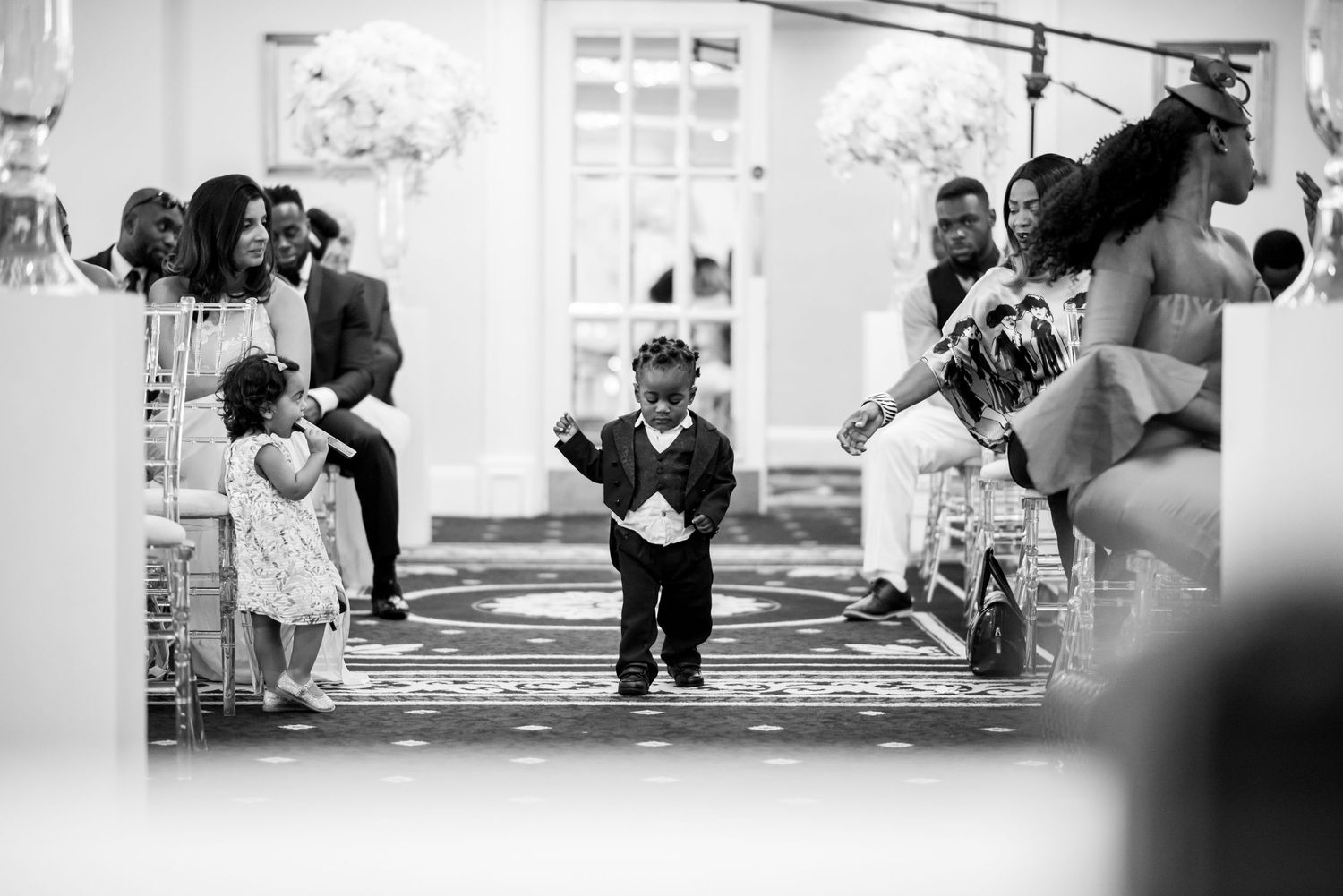 Candid black and white shots of wedding guests interacting during celebration.