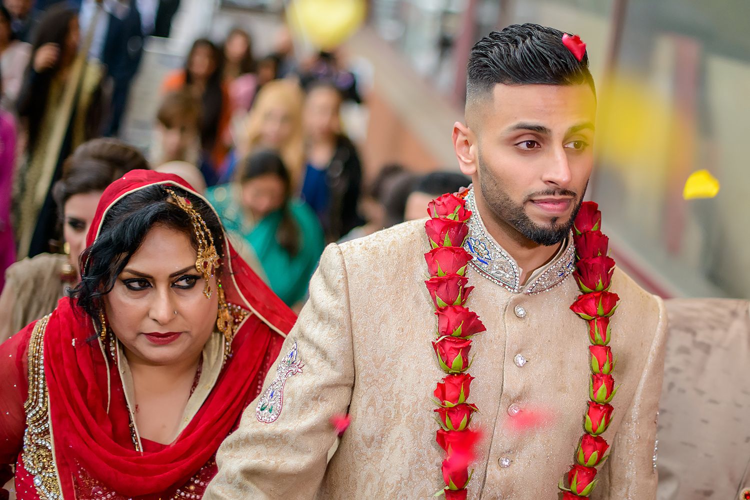 Traditional Indian wedding ceremony with guests in formal ethnic attire.