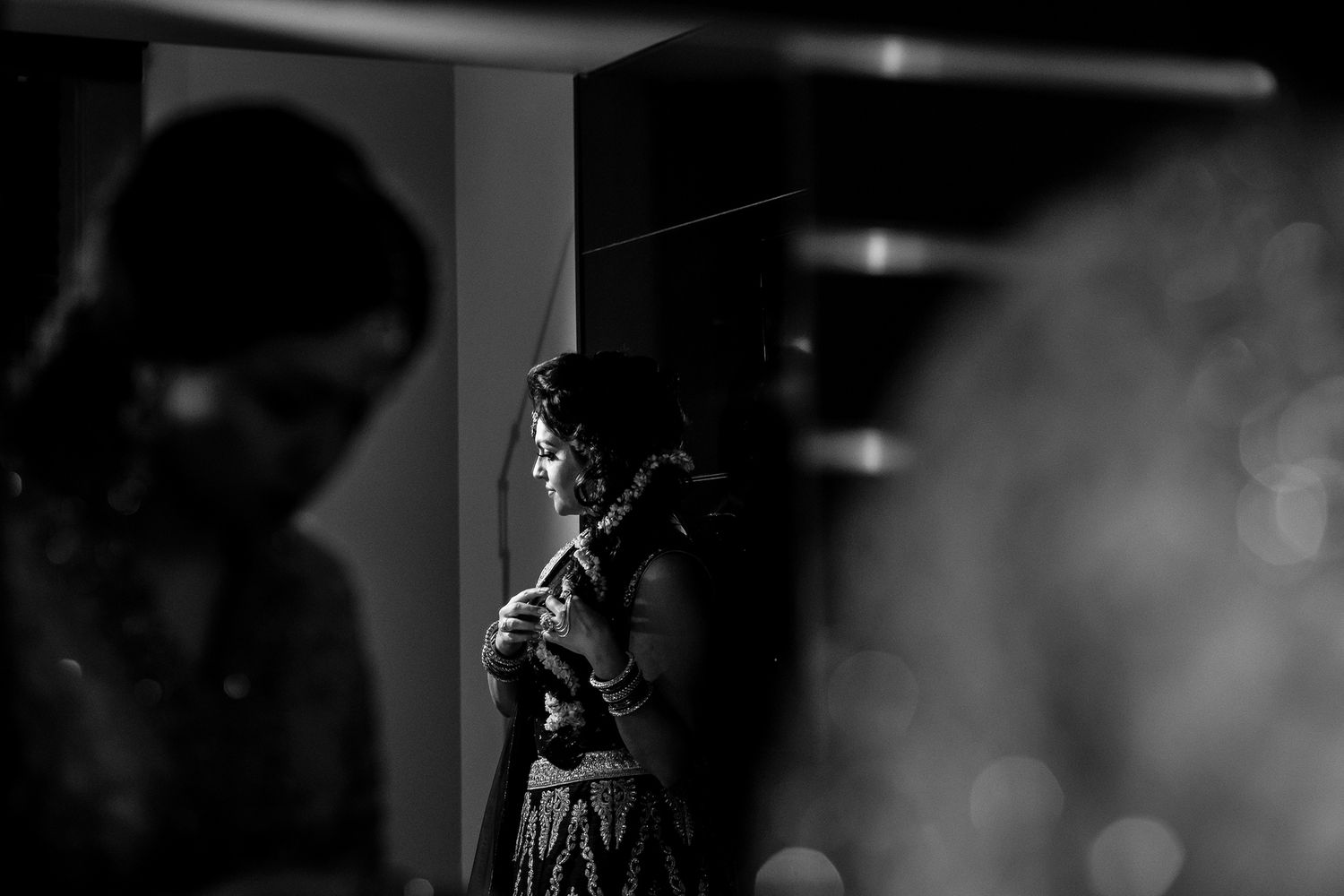 Silhouetted figures create dramatic lighting effects during an indoor celebration.