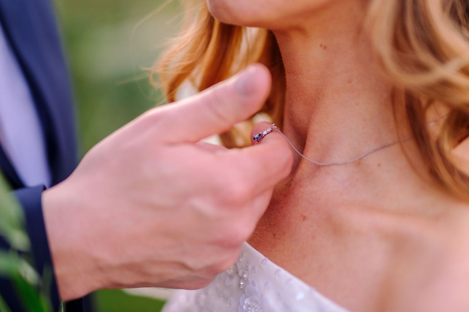 Close-up detail shot of wedding dress and jewelry.