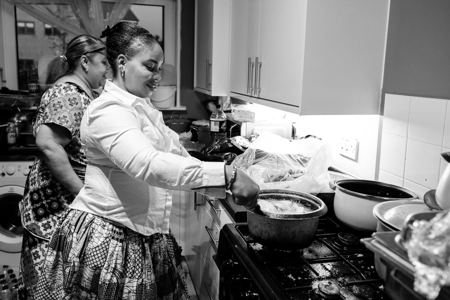 People working together in a bright kitchen setting with a professional atmosphere.