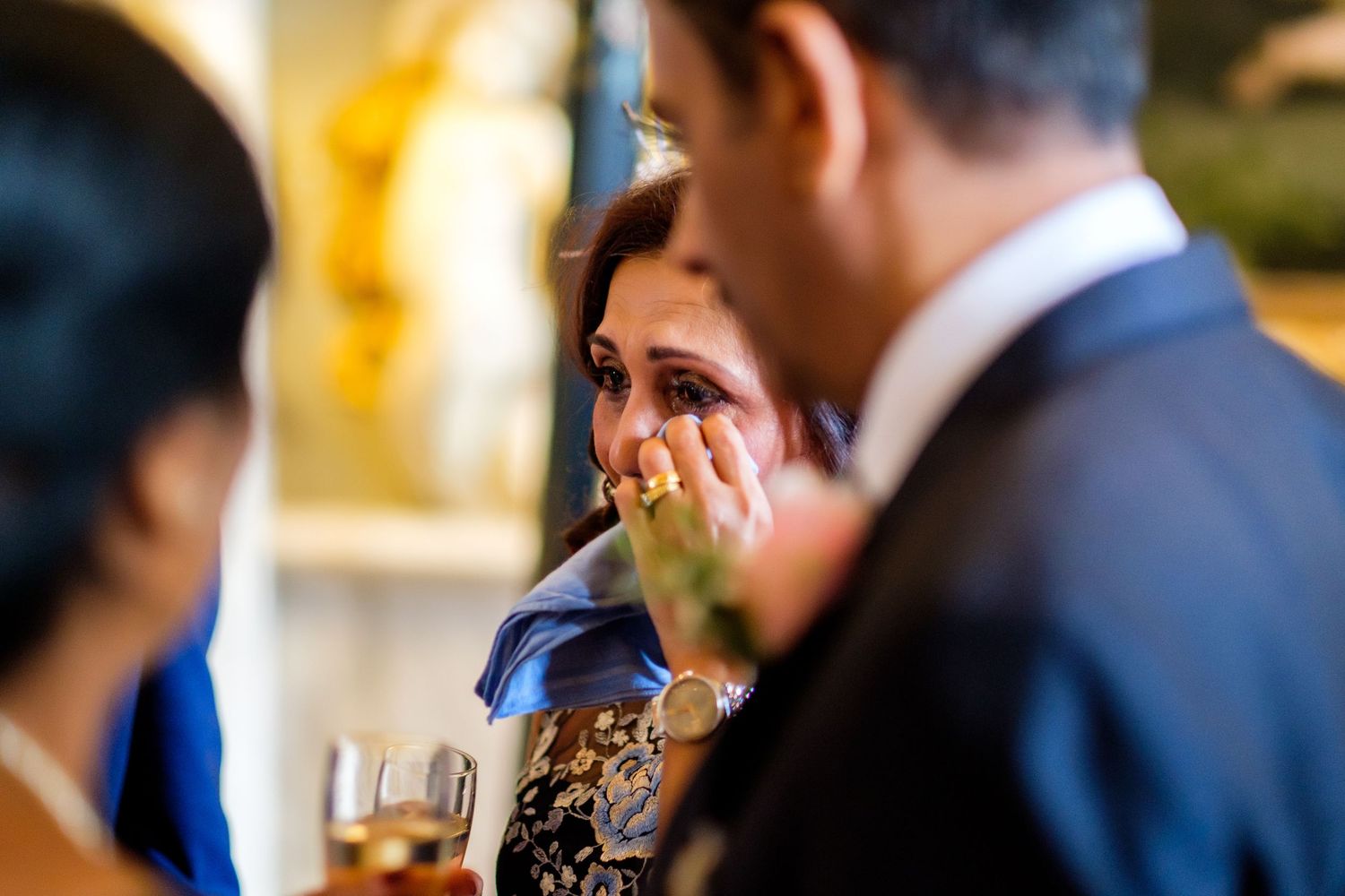 Wedding guests enjoy drinks and conversation during an evening reception.
