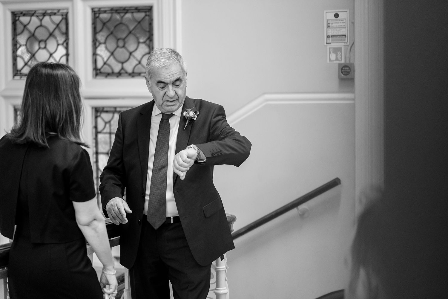 Monochrome candid photos of guests at formal indoor event.