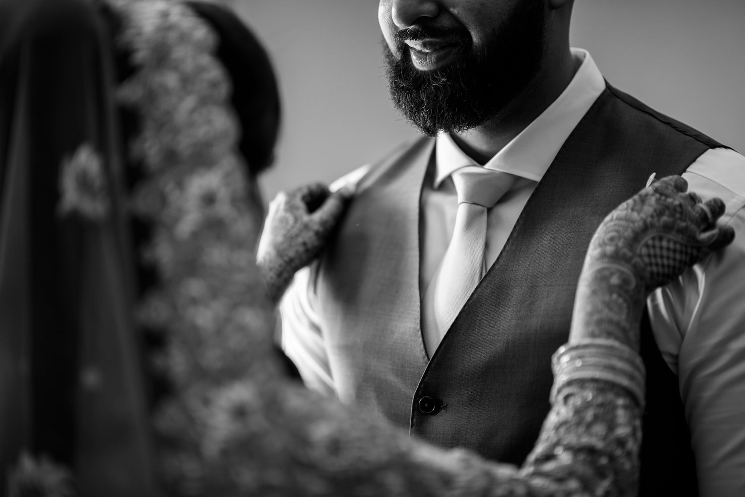 Black and white portrait showing formal attire details of wedding participants.