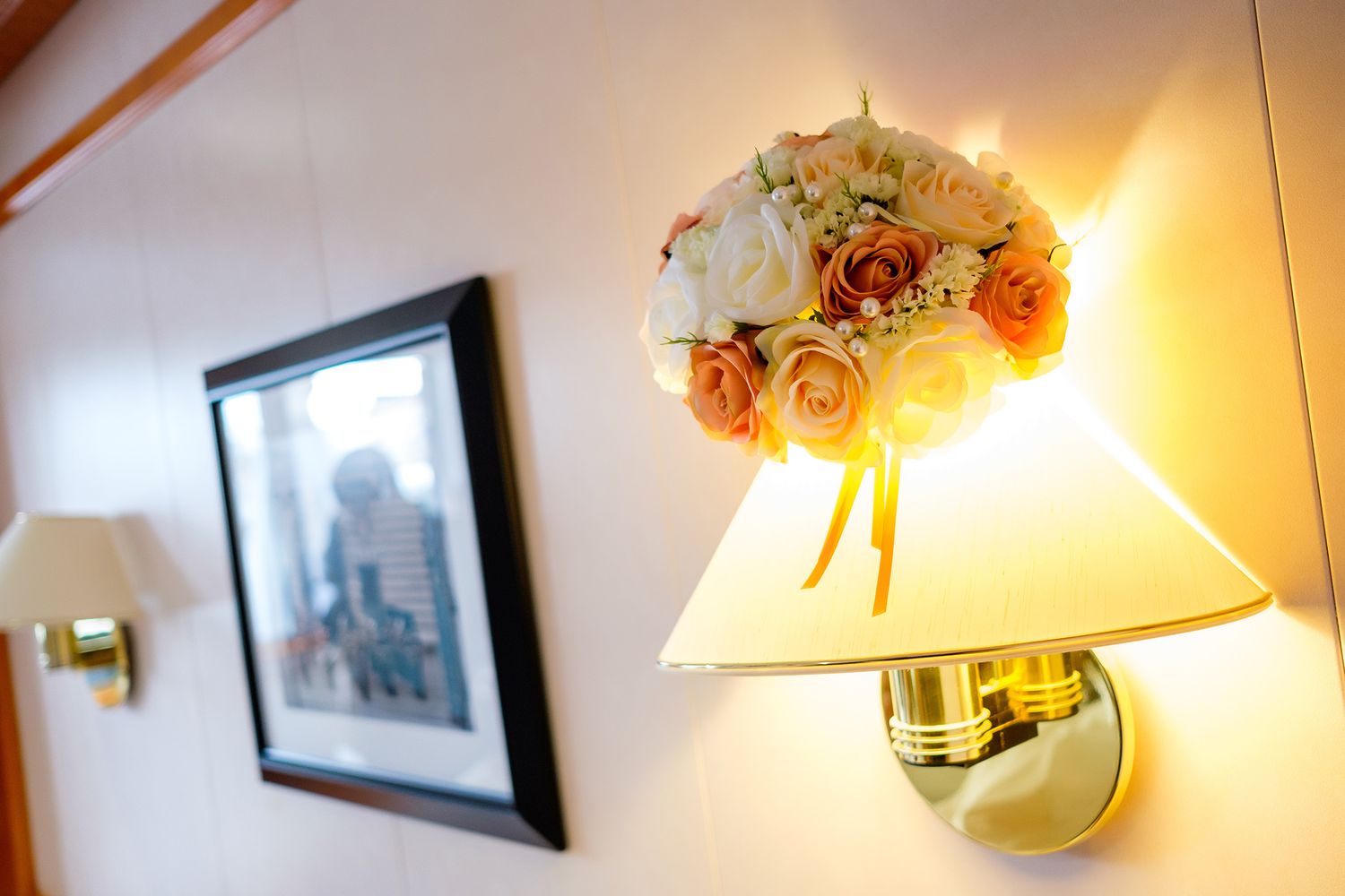 Warm-lit interior room with floral lamp shades and wall sconces creating an elegant ambiance.