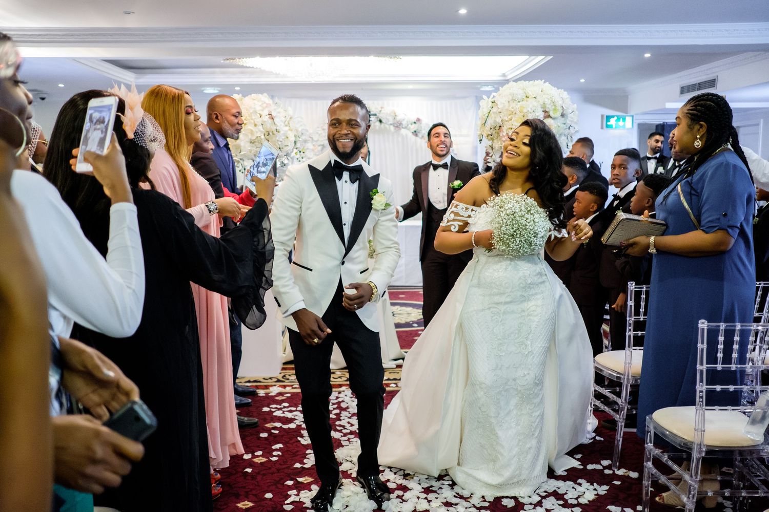 Wedding guests gather around the dance floor during a joyous celebration.