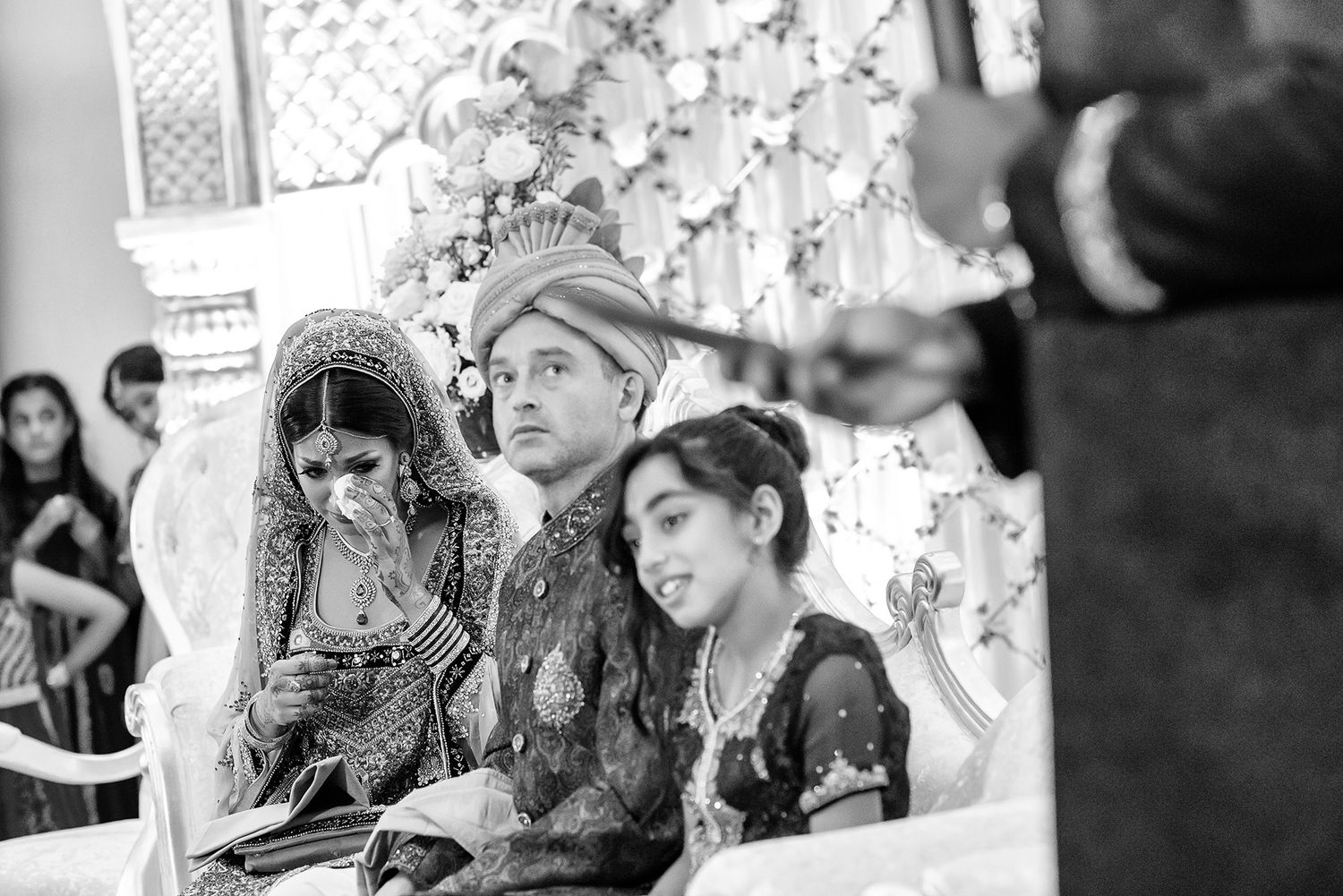 Black and white candid shots of wedding reception guests enjoying the celebration.