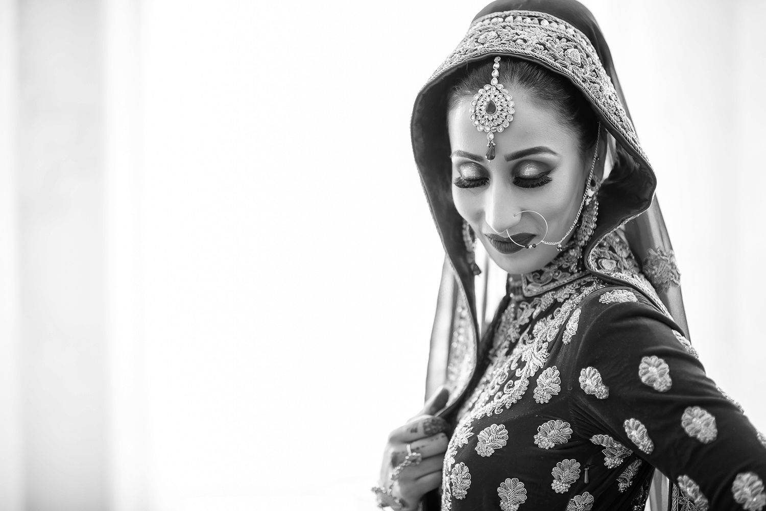 Traditional South Asian bridal makeup and jewelry preparation.