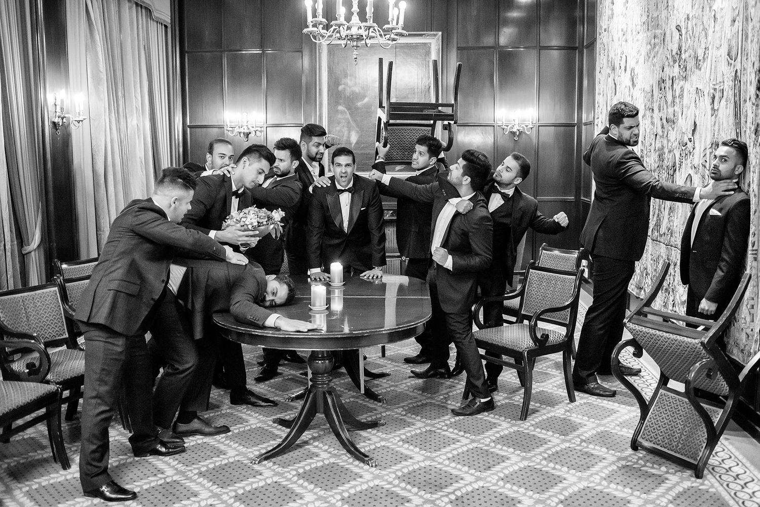 Black and white photo showing a group training session with seated participants in a formal meeting room.