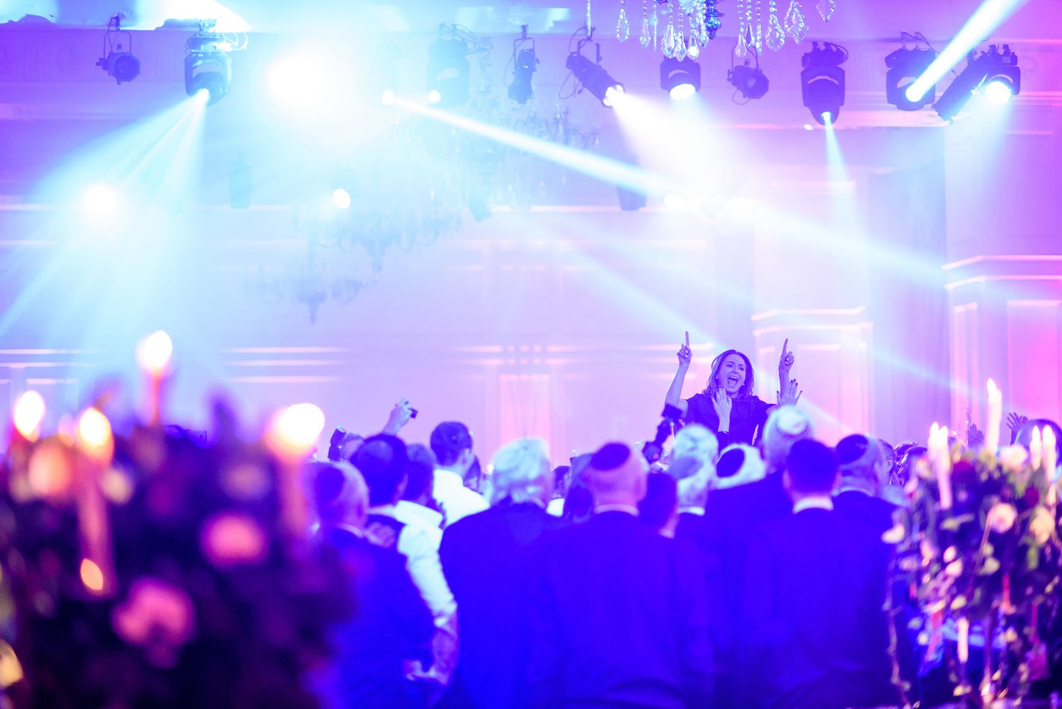 Energetic nightclub scene with purple and blue lighting effects creating atmosphere.