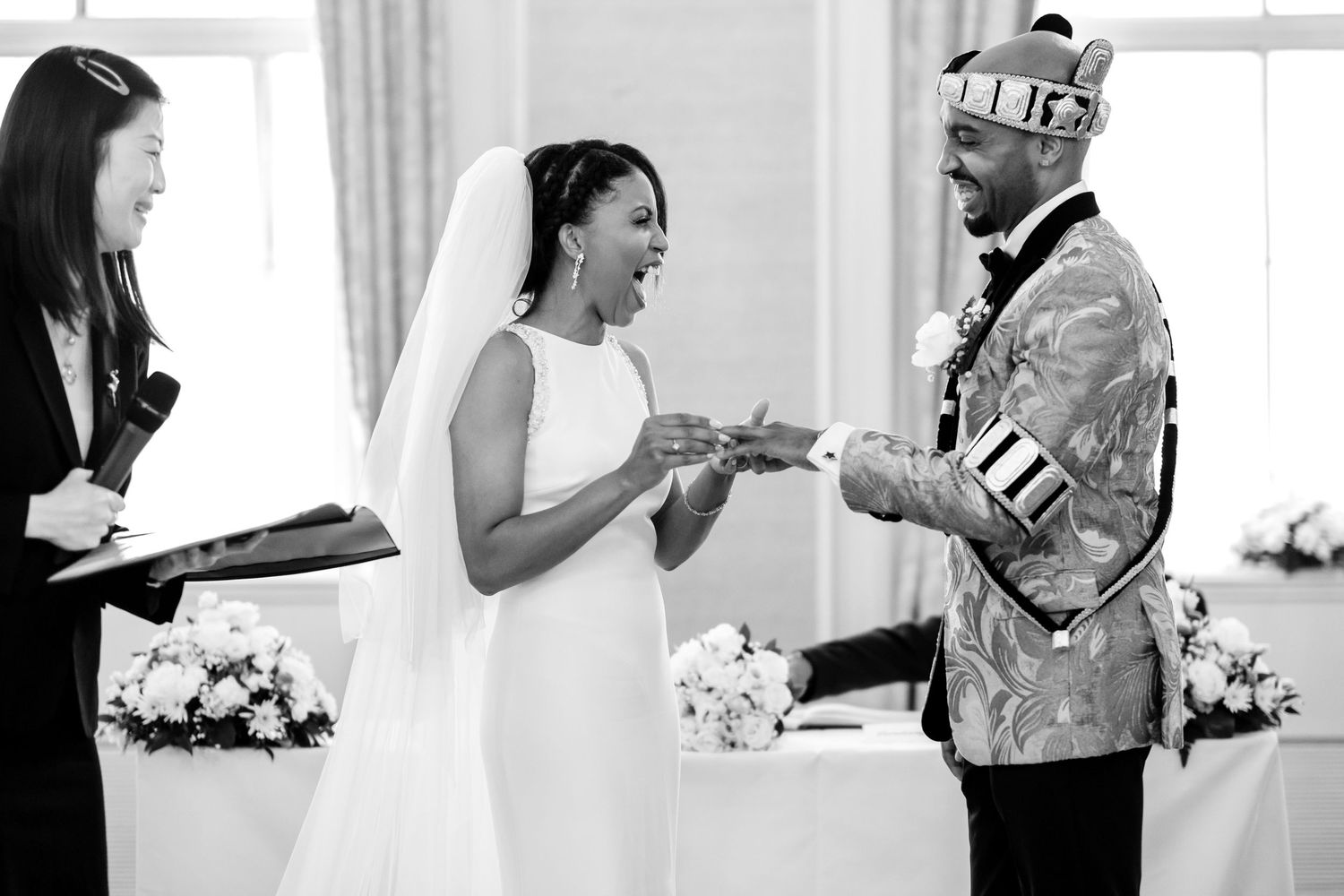 Wedding ceremony preparations with floral arrangements in a bright indoor venue.