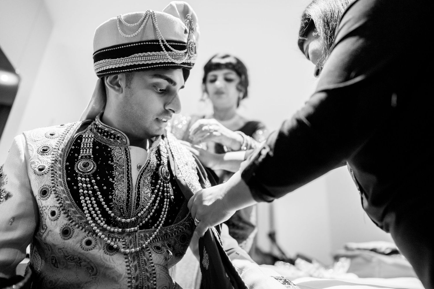 Black and white photo series showing guests mingling and interacting at a social gathering.