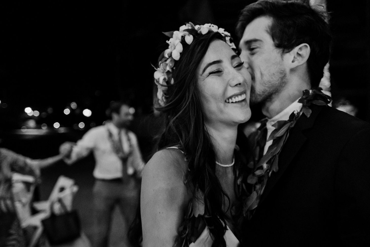 Five black and white romantic photos showing couples sharing intimate moments at a wedding celebration.