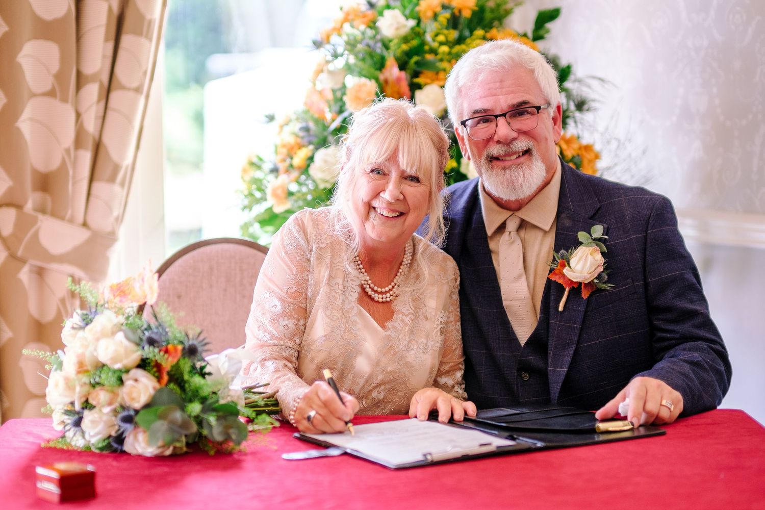 Wedding couple sharing intimate moments at their reception with floral decorations.