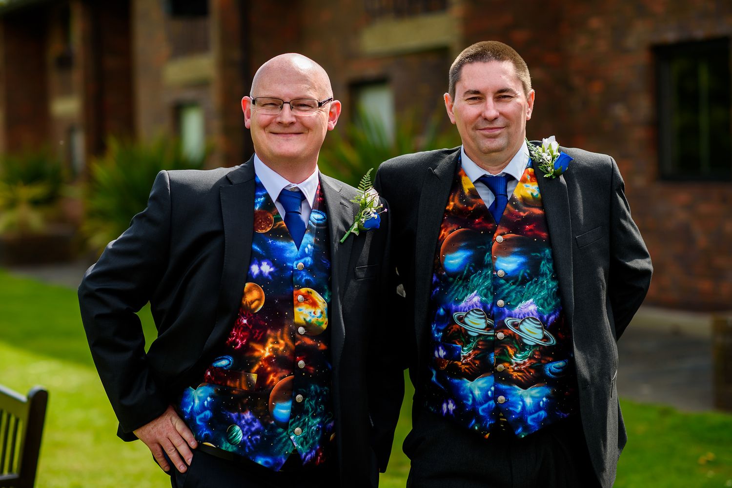 Wedding party members wearing vibrant floral-patterned vests pose outdoors.