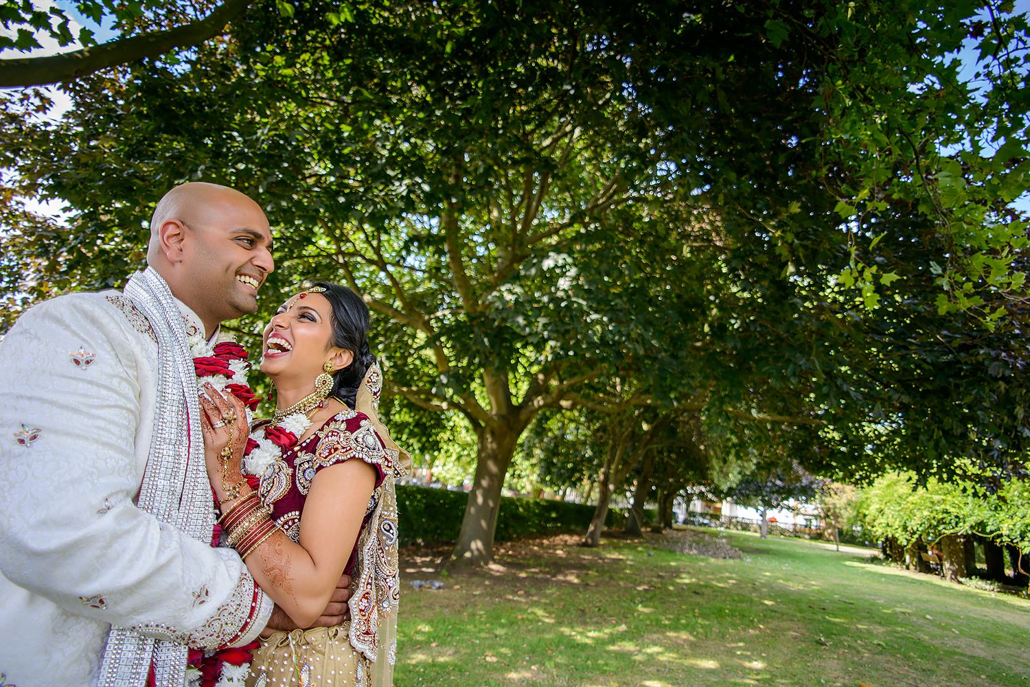 Outdoor wedding photography session in a lush green garden setting.