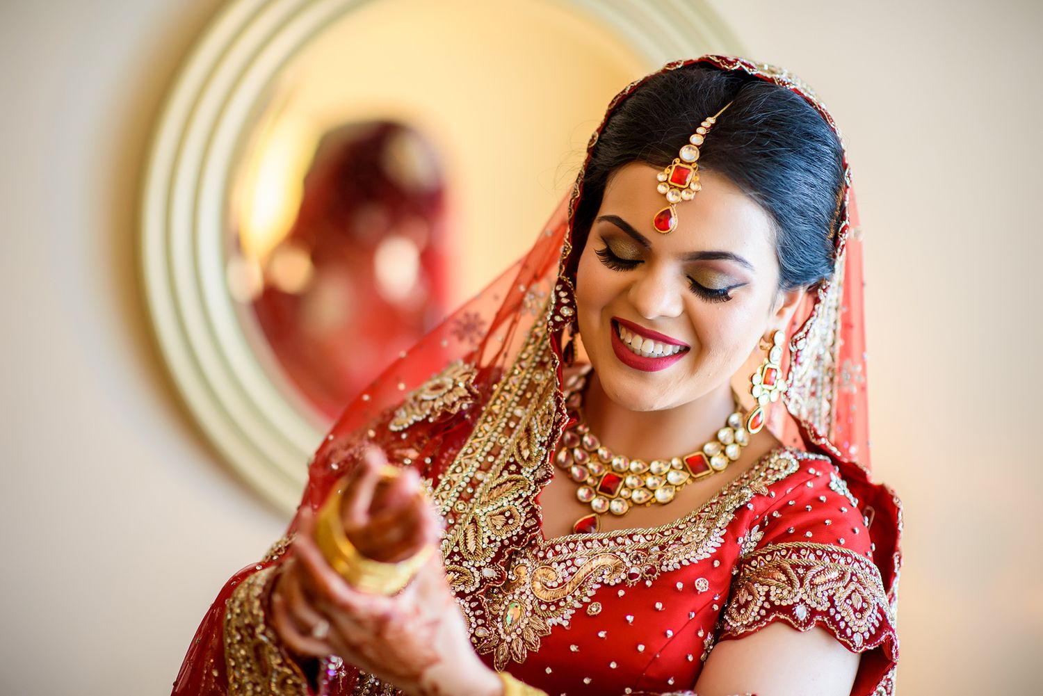 Traditional Indian bridal attire with intricate embroidery and jewelry details.