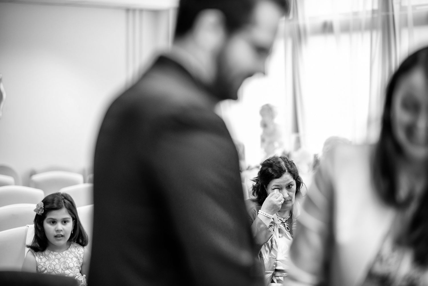 Professional colleagues having animated discussions in a bright office setting.