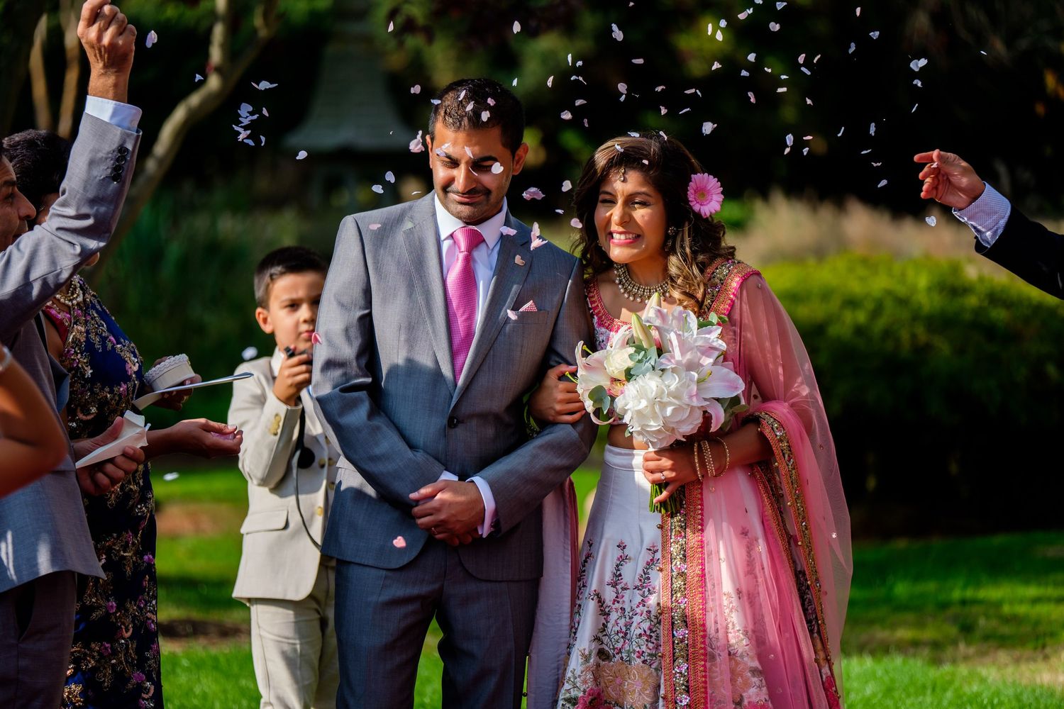 Colorful confetti fills the air as celebratory scene unfolds at outdoor wedding.