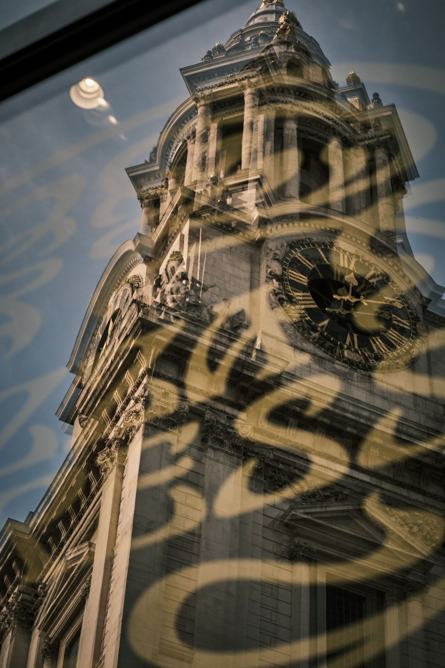 Architectural detail of a historic church tower with dramatic shadows and clock face.