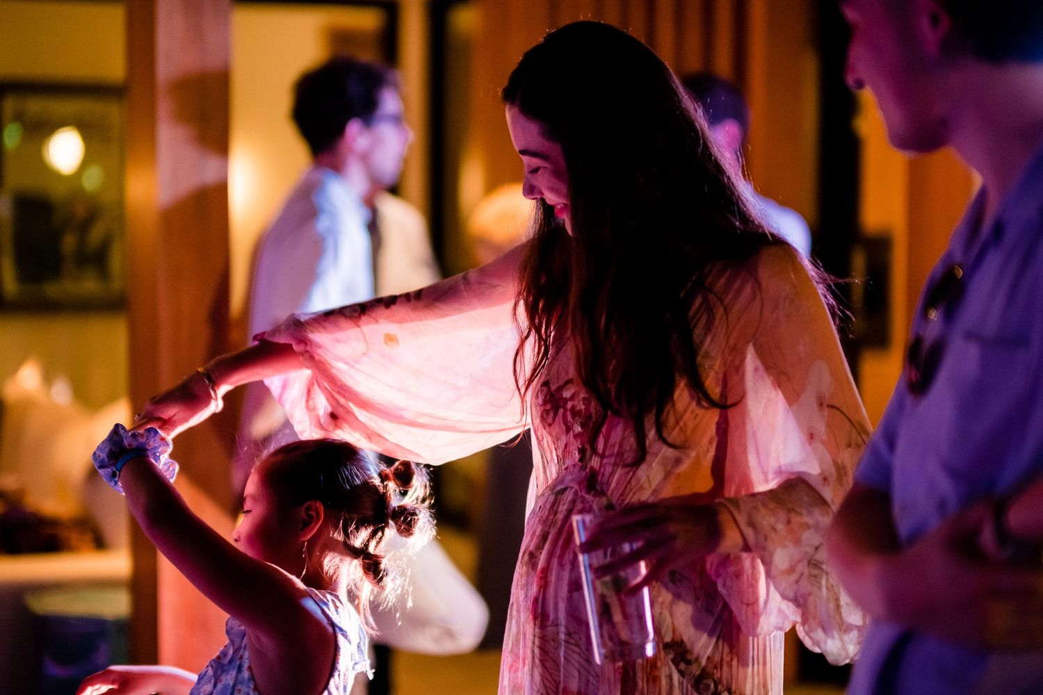 People dancing together at an evening reception with warm lighting and festive atmosphere.