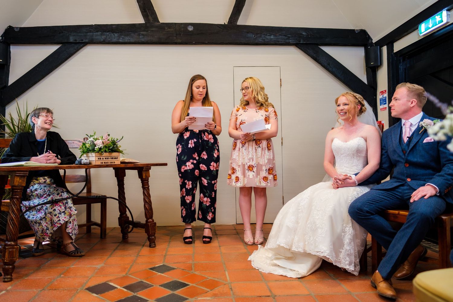 Wedding guests seated in rows at an indoor ceremony venue.