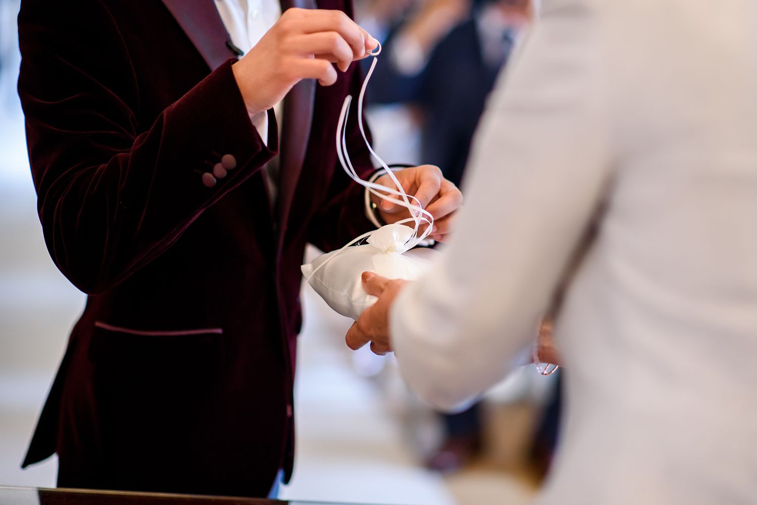 Formal event guests mingling and holding drinks at an elegant reception.