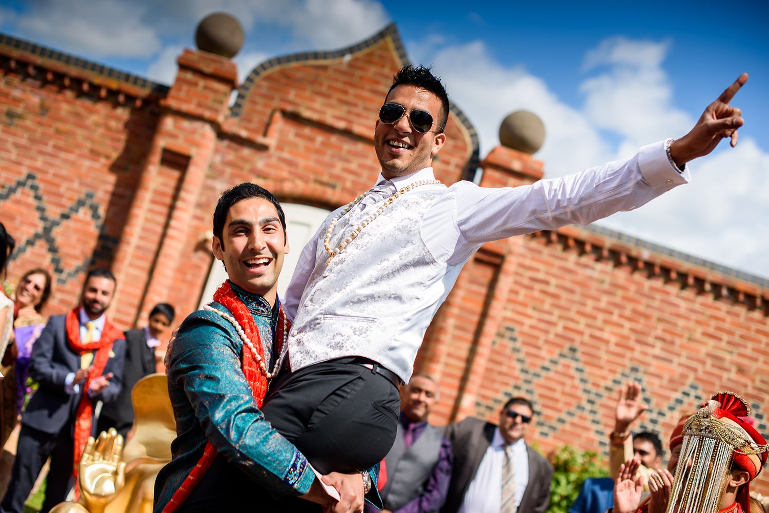 Celebratory dance moves performed during outdoor Indian wedding festivities.