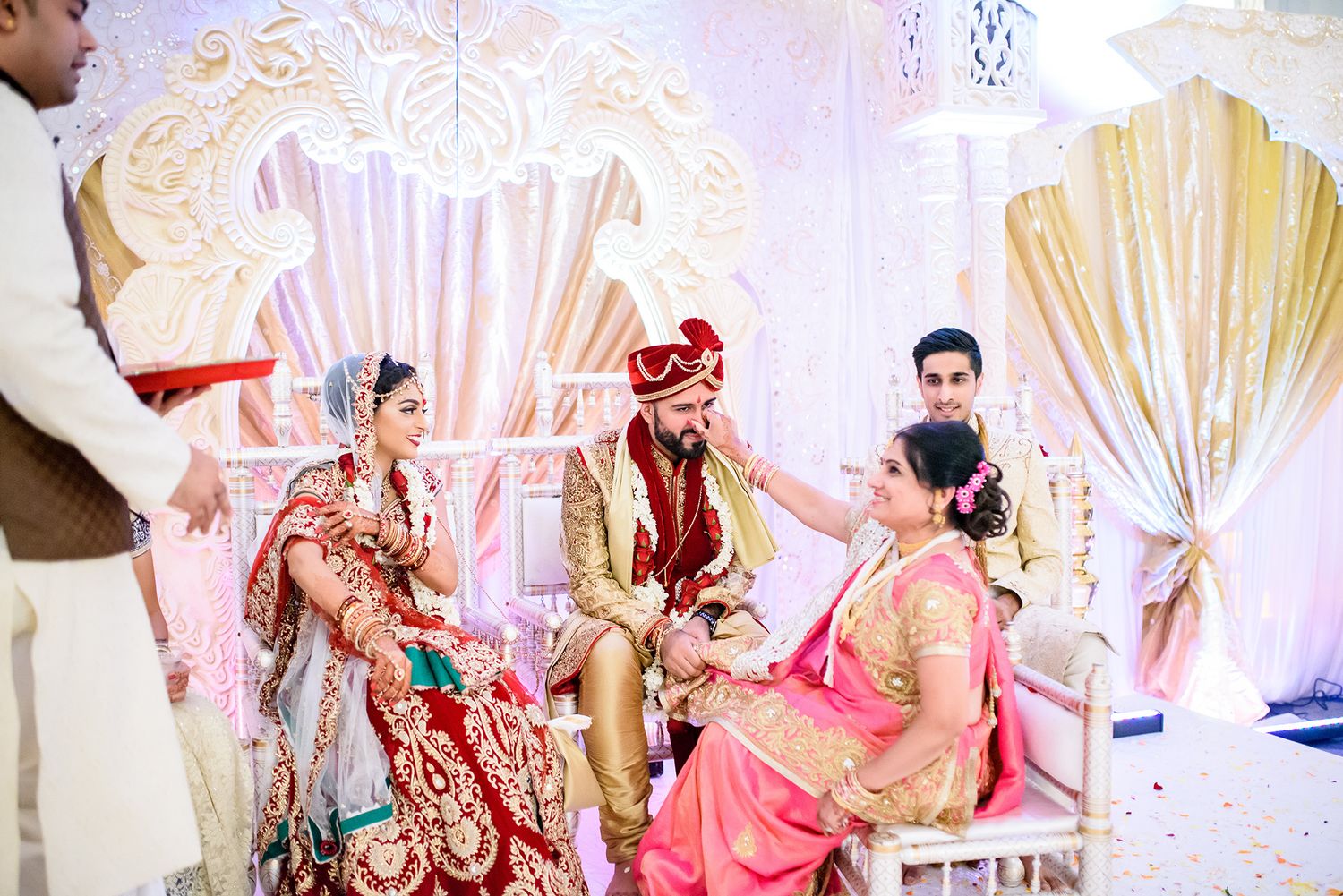 Elegant white and gold wedding mandap decorated for traditional Indian ceremony.