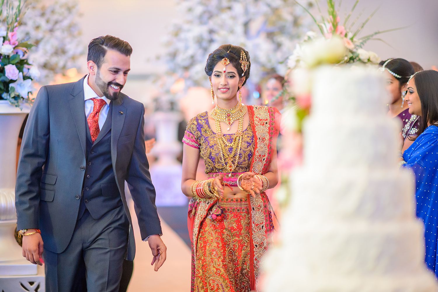 Candid moments from a cultural fusion wedding celebration with traditional Indian and Western elements.