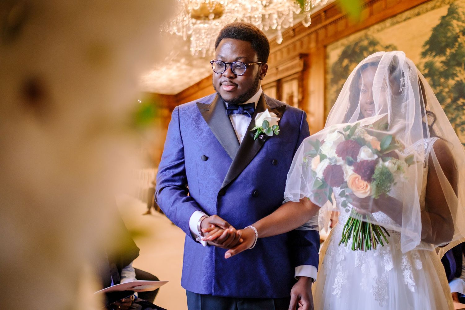 Wedding couple shares an intimate moment in a beautifully decorated indoor venue.