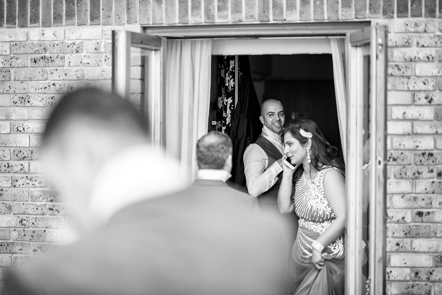 Wedding venue exterior featuring classic brick architecture and white trim details.