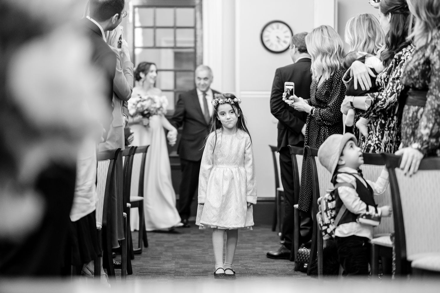 Elegant black and white wedding photos showing guests celebrating at an indoor venue.