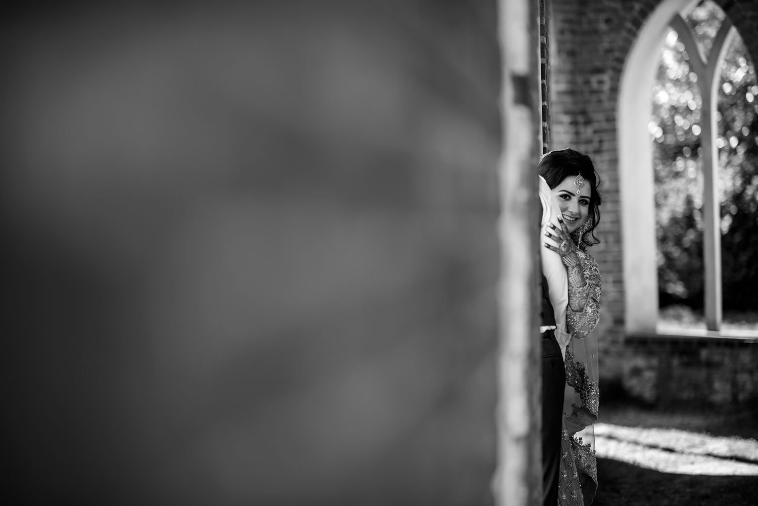 Silhouette against brick wall with dramatic lighting and architectural elements.