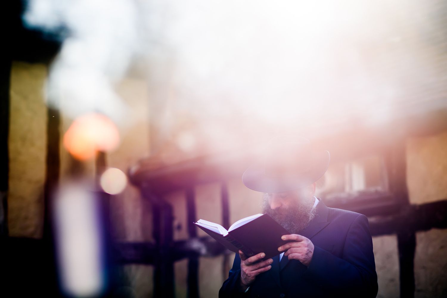 Soft focus silhouettes of people against bright backlight create an atmospheric event scene.