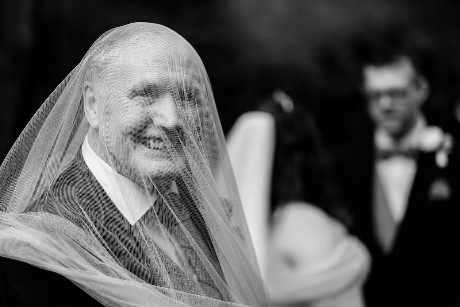 Black and white emotional wedding portraits with veil details.