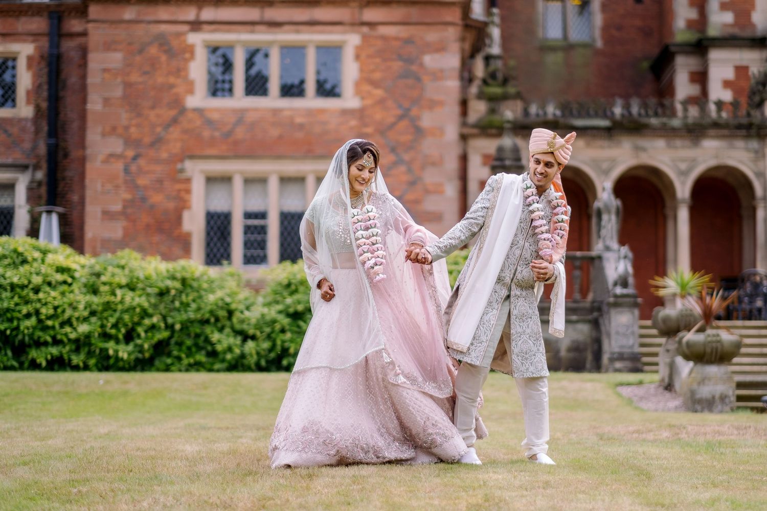 Wedding photo session in front of historic brick building with classic architecture.
