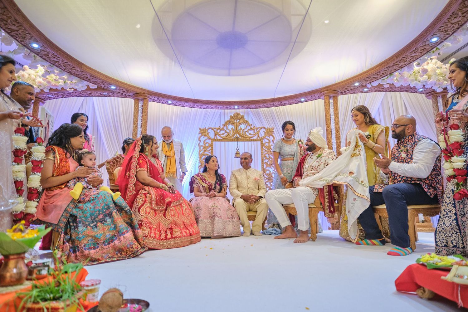 Panoramic view of a luxurious wedding venue with domed ceiling and traditional Indian decorations.
