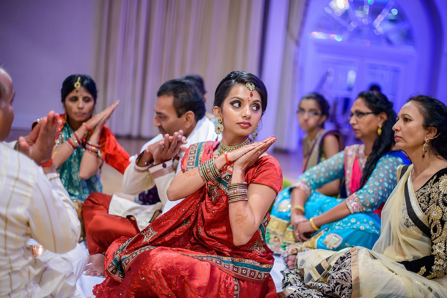 Guests in colorful traditional Indian attire during a wedding celebration.