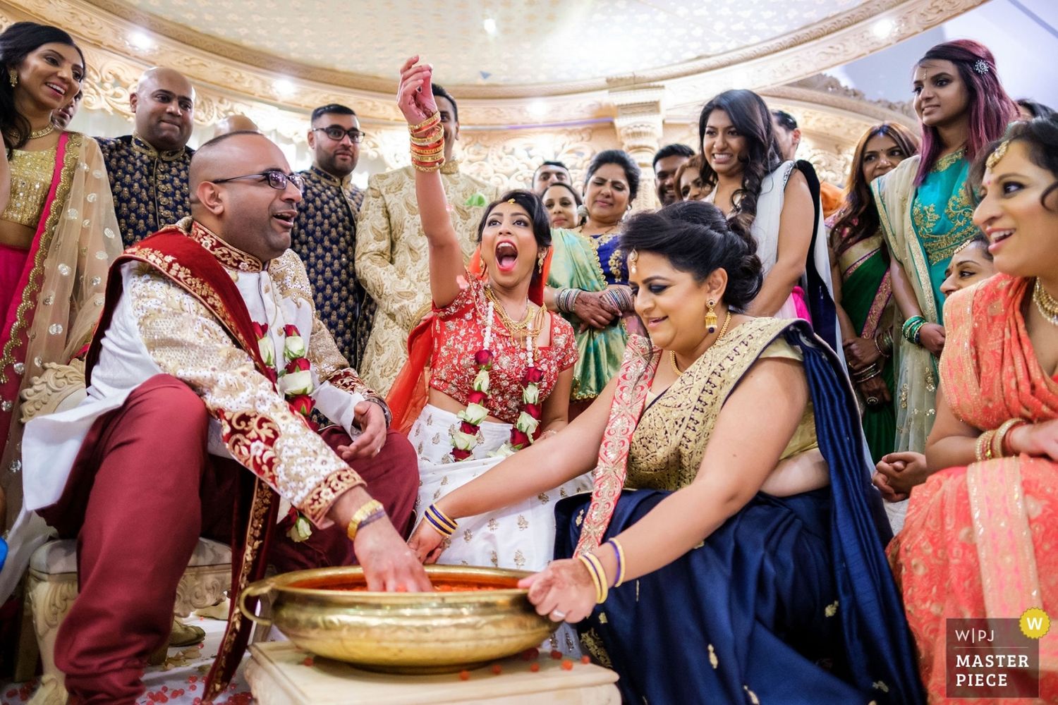 Joyful celebration at an elegant Indian wedding reception with guests dancing and mingling.