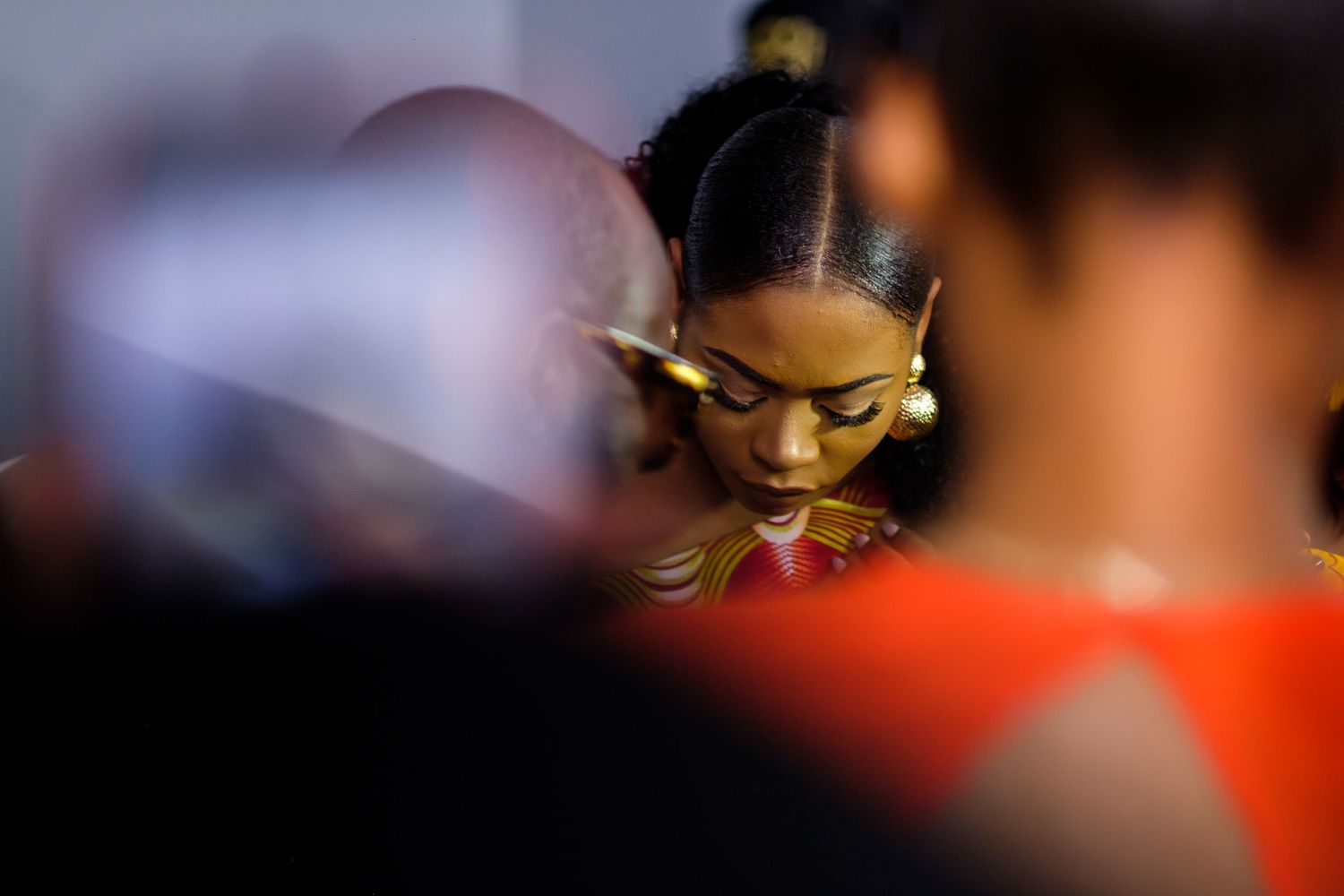An artistic close-up shot in moody lighting showing yellow eyeshadow makeup detail.