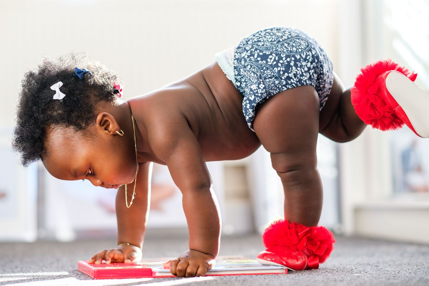 Series of crawling baby dressed in sparkly outfit and red accessory shown from different angles.