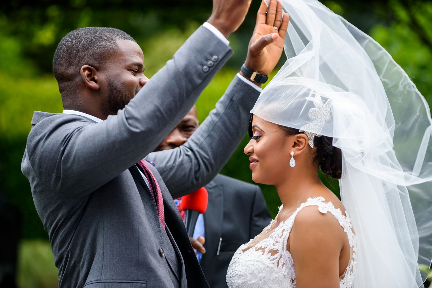 A joyous wedding celebration captures special moments between the couple and guests in a lush outdoor garden setting.