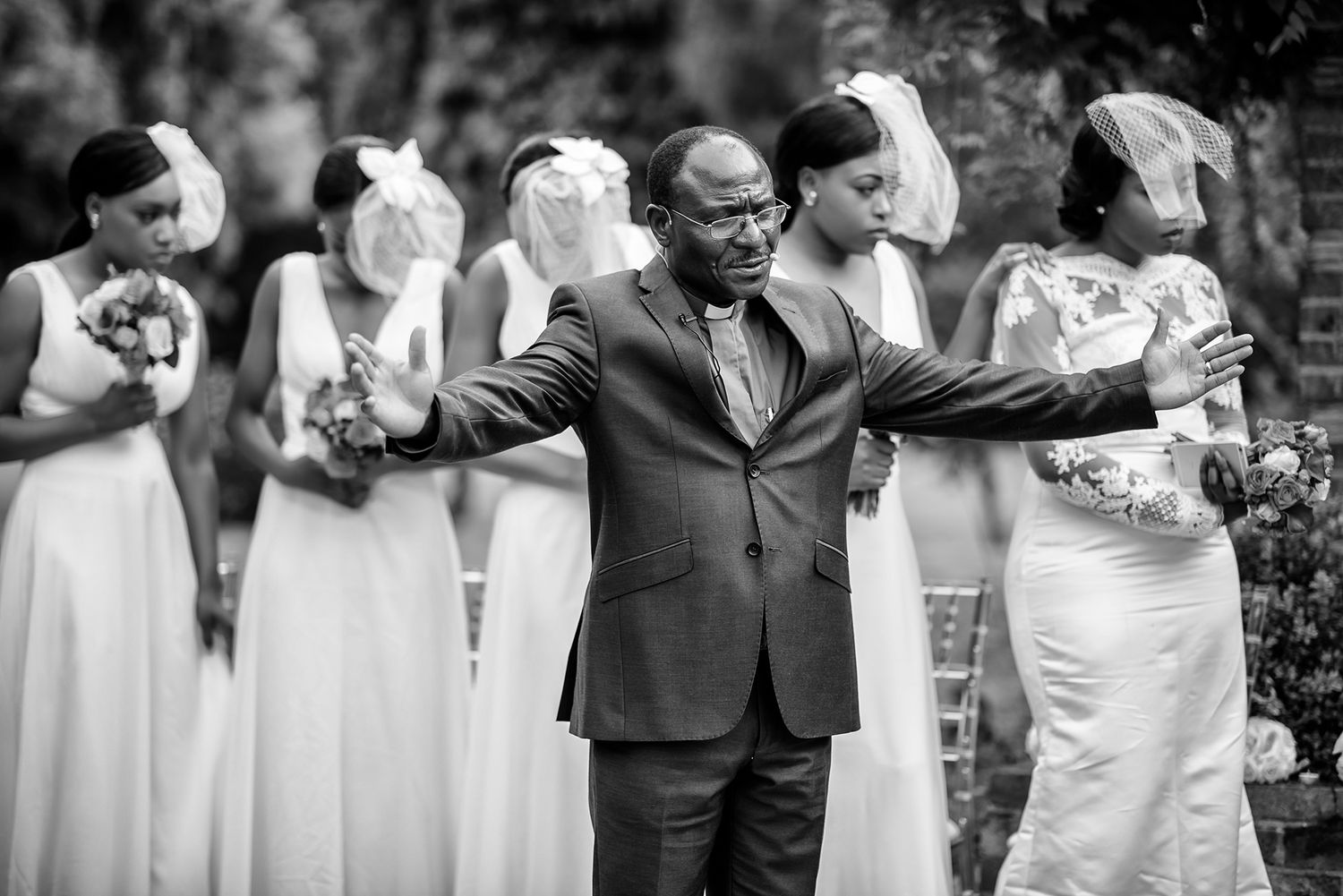Wedding party posing in formation wearing formal black and white attire.