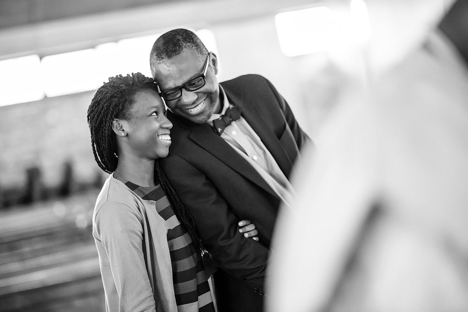 Close-up black and white portraits capturing intimate wedding moments between a couple.