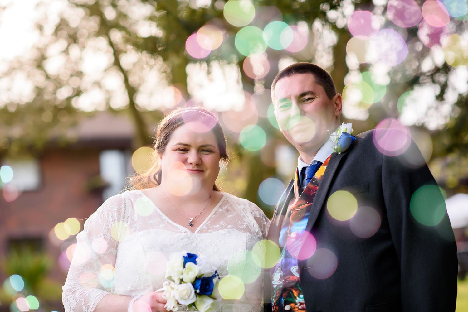 Bokeh lights and bubbles create a magical atmosphere at an outdoor wedding.