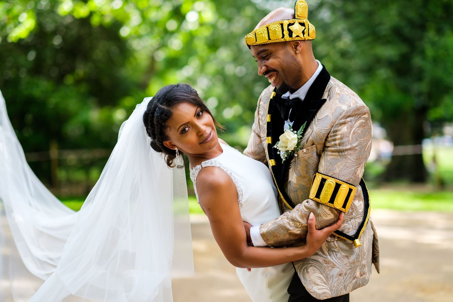 Wedding couple poses for outdoor photos in a lush garden setting with natural greenery.